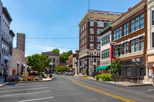 A street line with low rise brick facade buildings in Alton's historic district