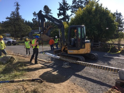 A crew of Rock Island Communications network builders operate a tractor 