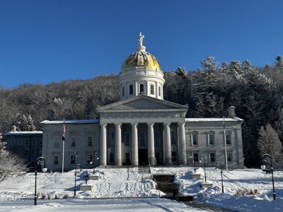 Vermont State House building on a sunny day after snowfall