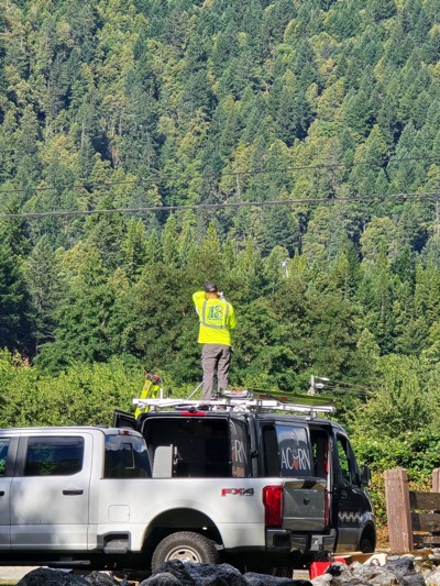 Hoopa Valley worker stands on top of Acorn Connected van