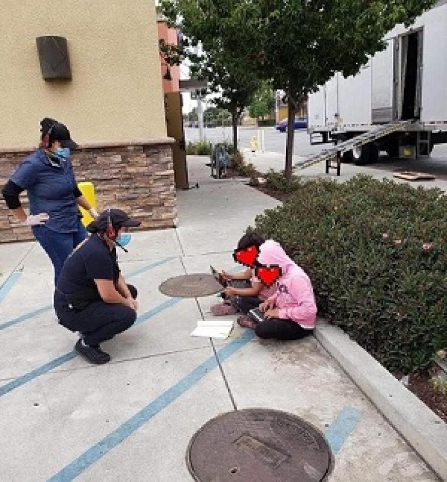 students in fast food lot using WiFi