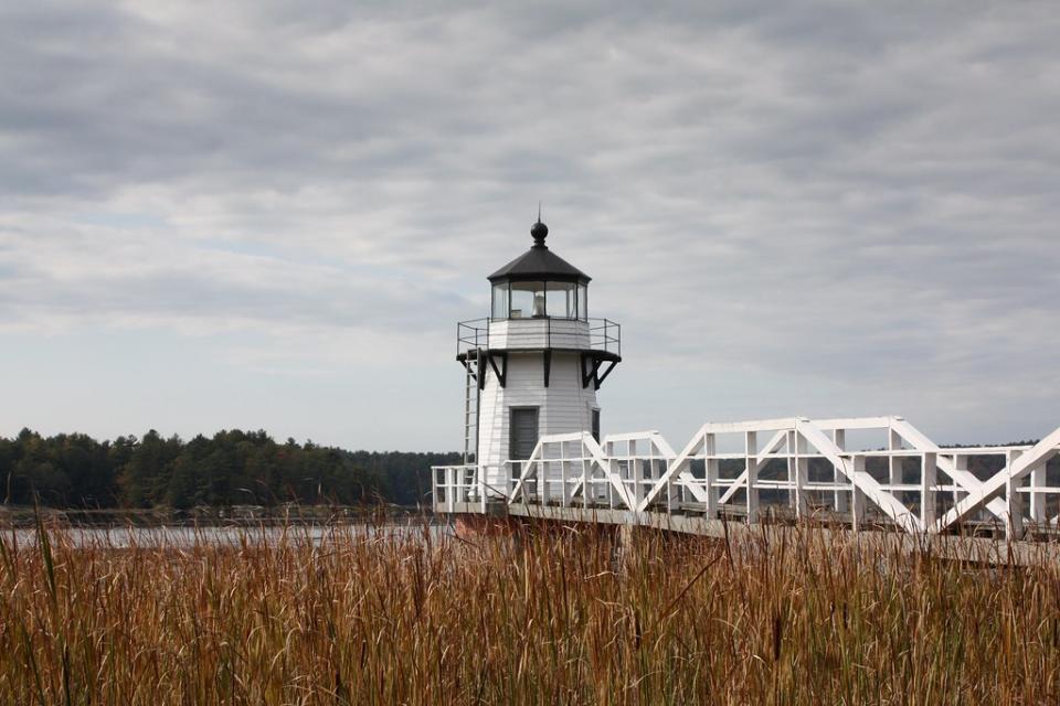 lighthouse and wooden pier in Arrowsic Maine