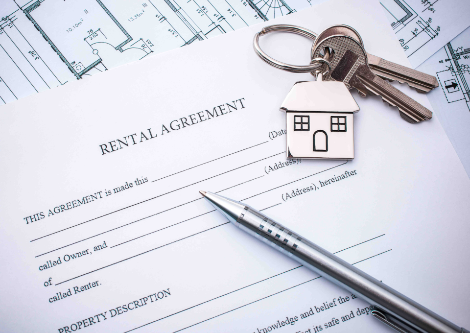 A blank rental agreement form with a pair of keys on top
