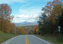 Essex VT road with view of Lake Champlain and Camel's Hump in the background