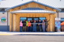 A dozen Hoopa Valley Tribe members stand in front new network operations center preparing to cut ribbon